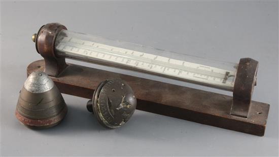 A wall mounted thermometer and two shell timer paperweights